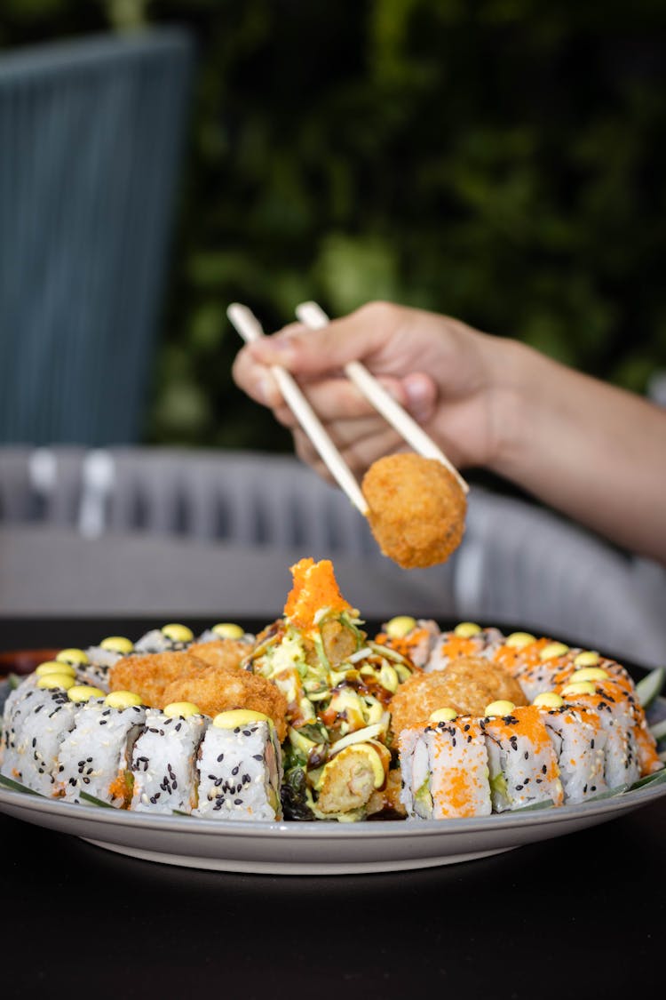 Woman Eating Sushi In A Restaurant