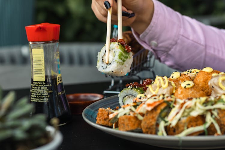 Woman Eating Sushi In A Restaurant