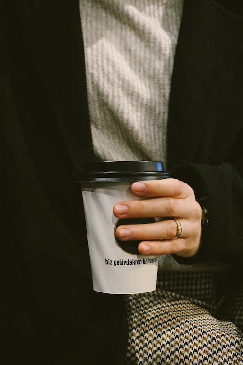 Close-up of Woman Holding a Disposable Cup of Coffee