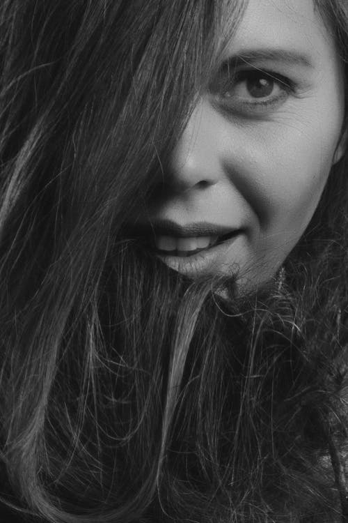 Grayscale Photography of Smiling Woman
