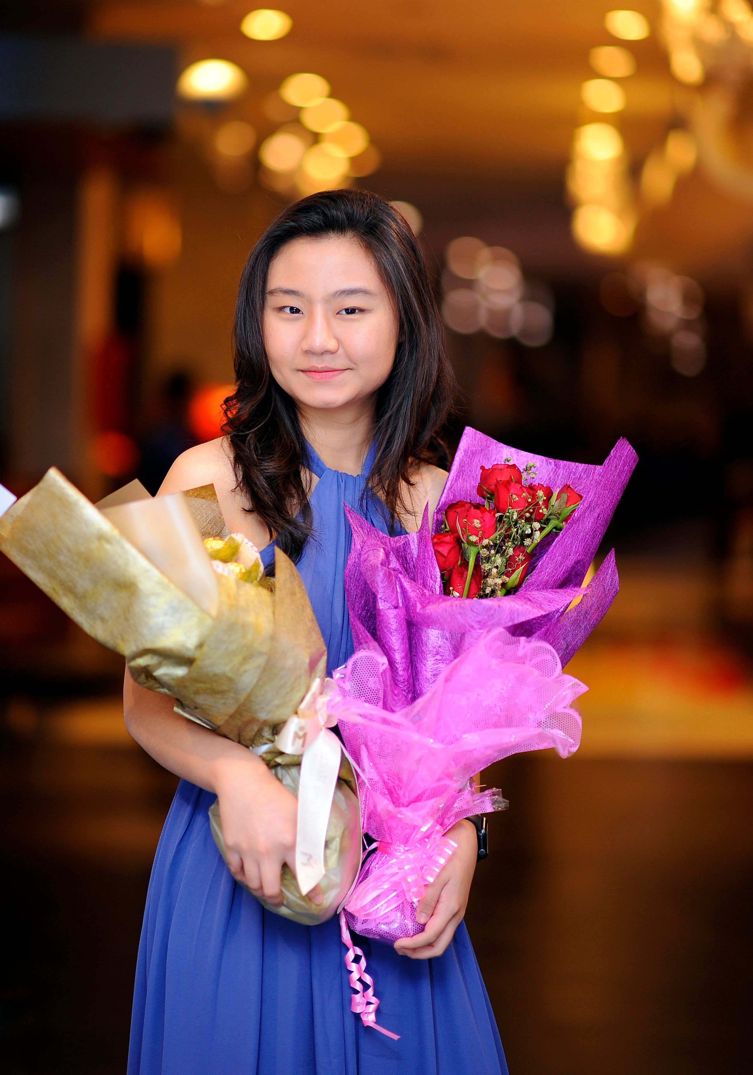 A Woman in Blue Dress Smiling while Holding Bouquet of Flowers · Free ...