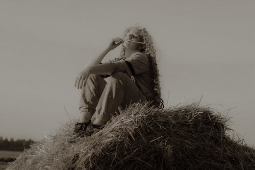 Woman Sitting on Haystack
