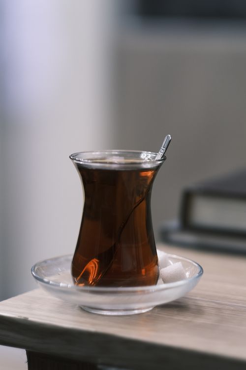 Free Close-up of a Turkish tea glass on a wooden table with sugar cubes. Stock Photo