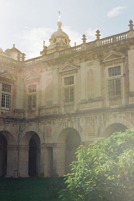 Explore the sunlit arches and historic architecture of a Lisbon cloister, showcasing Portugal's rich heritage.