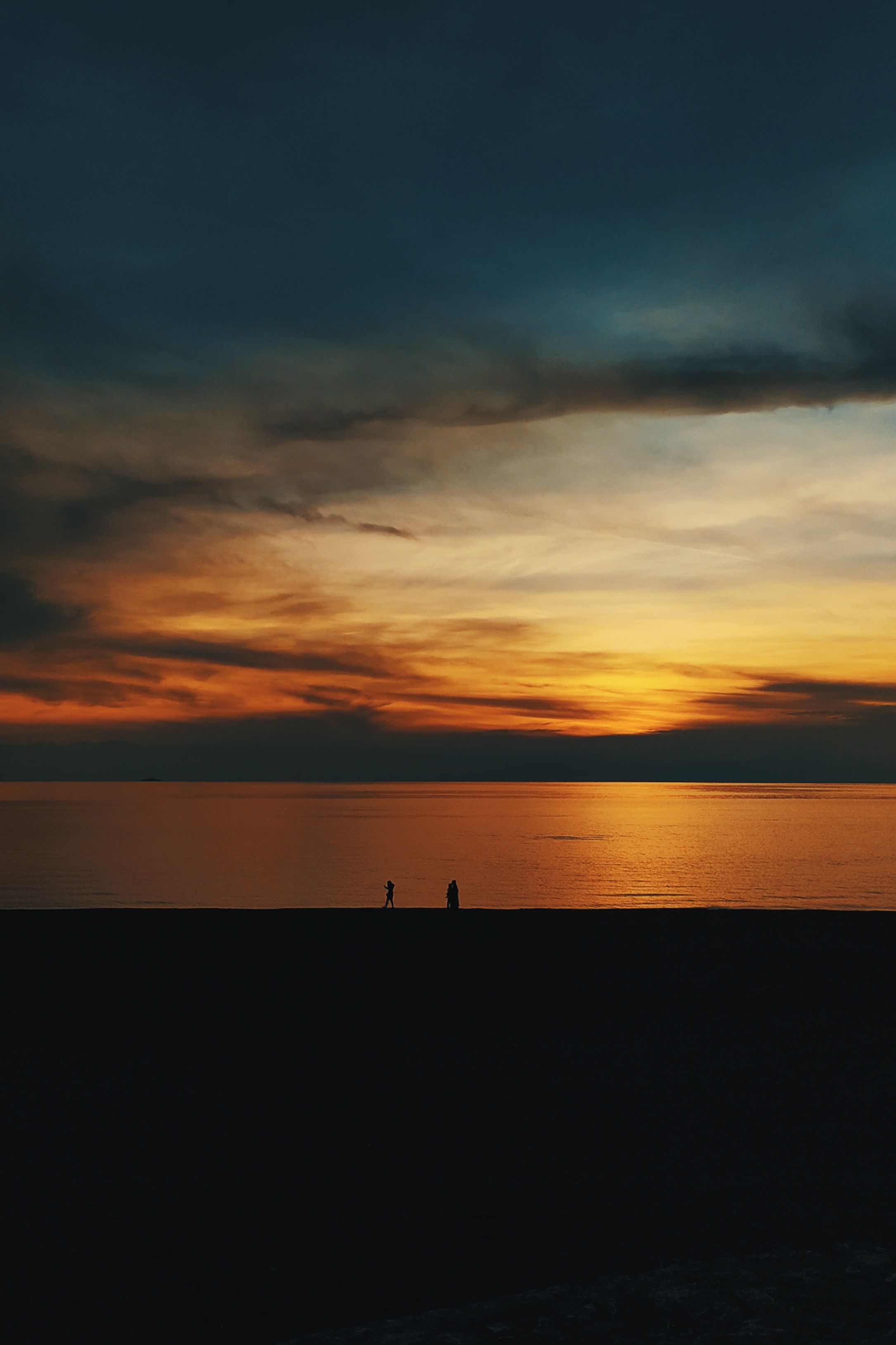 A Silhouette of a Body of Water During Golden Hour · Free Stock Photo