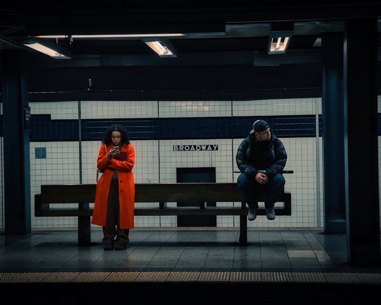 Woman And Man Waiting At Broadway Station In New York