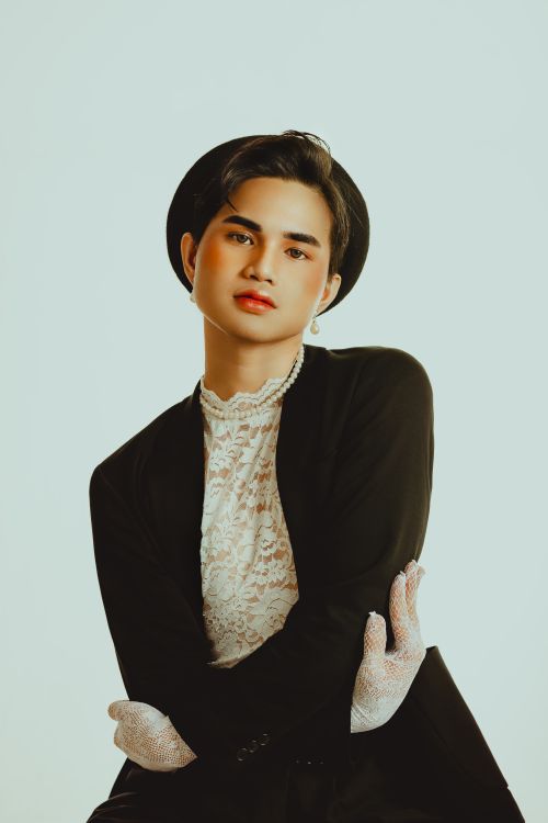 Free Vintage-inspired studio portrait of a fashionable man in lace and suit, exuding elegance and charm. Stock Photo