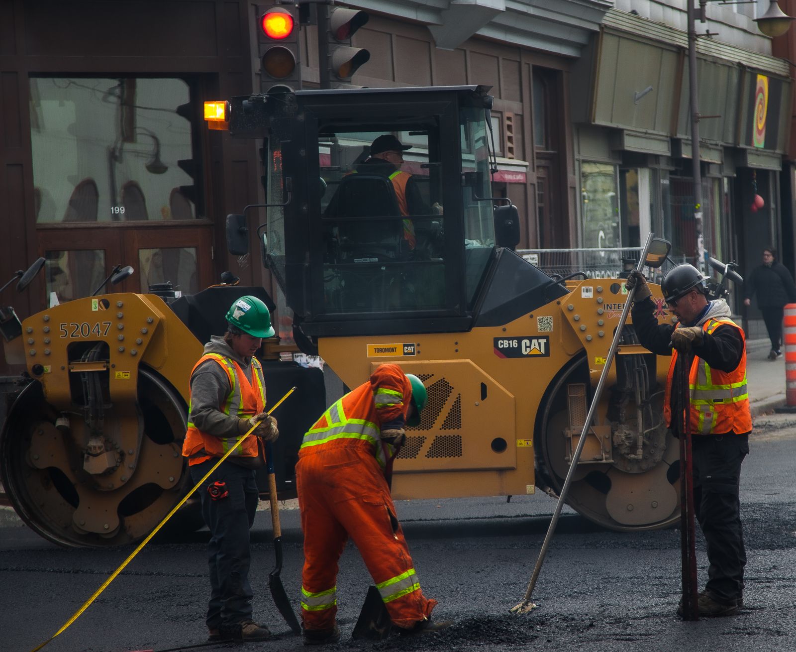 Asphalt paving crew with a roller machine — Before and After Gallery Website: How to Sell the Job