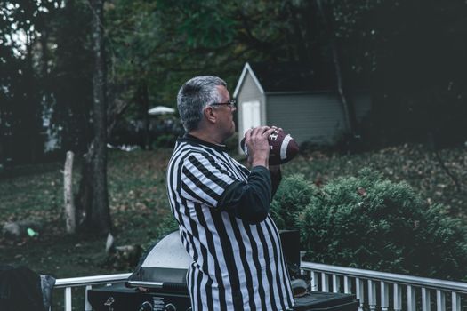 Man Holding Football on Outdoors