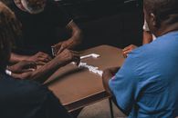 Four People Playing Domino