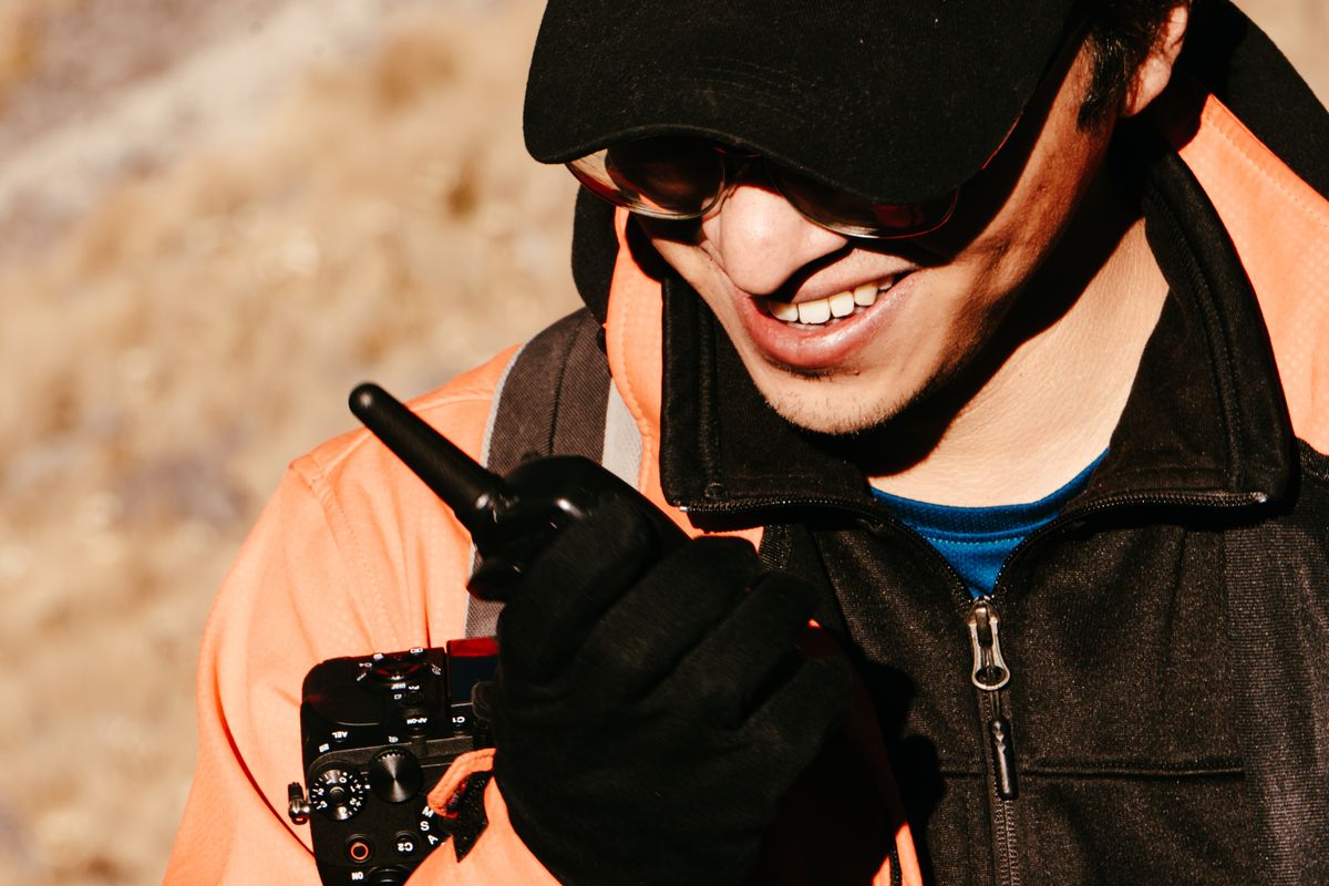 Explorer using handheld two-way radio outdoors