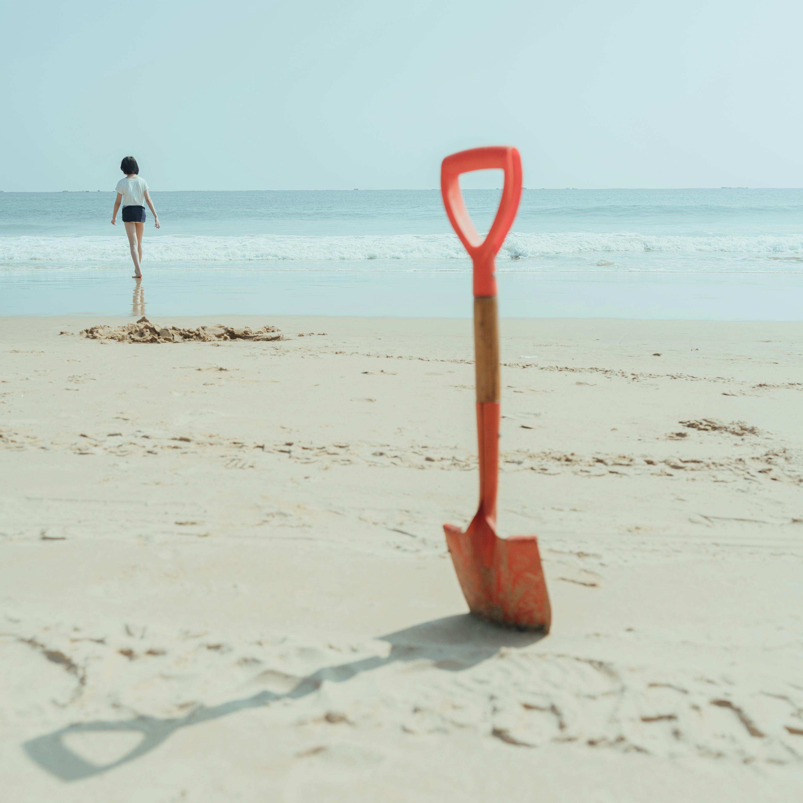 An Orange Shovel on Brown Sand · Free Stock Photo