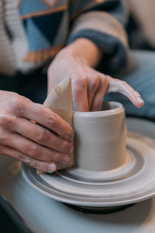 Polishing Mug on Potter Wheel