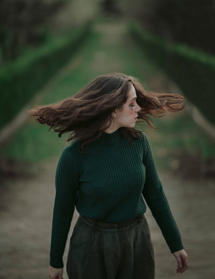 Woman In Green Clothes In A Forest