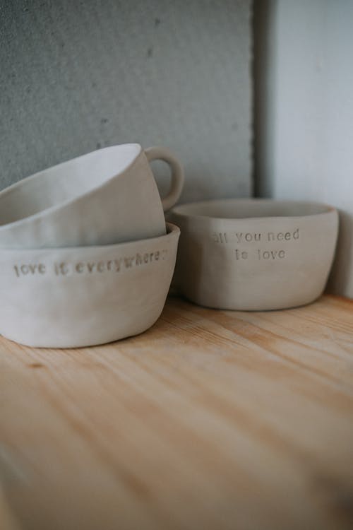 Close-up of Ceramic Mugs Standing on a Wooden Surface