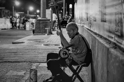 Elderly Street Artist with Musical Instrument