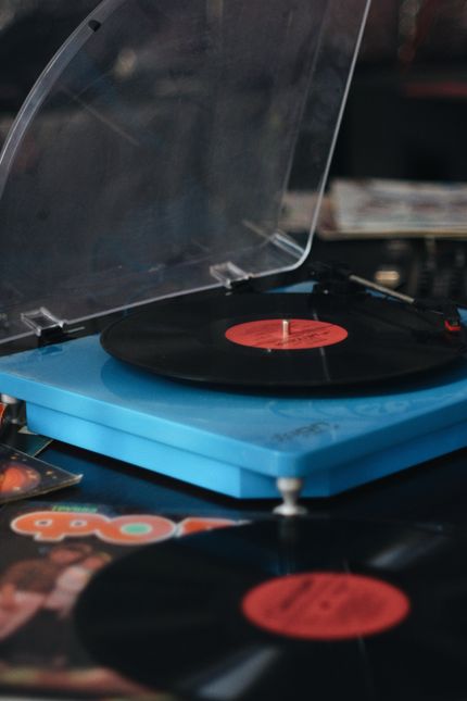Turntable and stacked records — photo by Sergei Bezborodov on Pexels