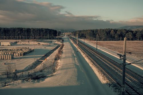 Free Snowy rural landscape in Styria, Austria with railway tracks and fields. Stock Photo