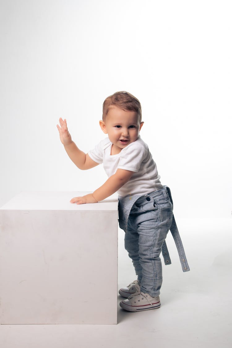 Cute Toddler In White Studio