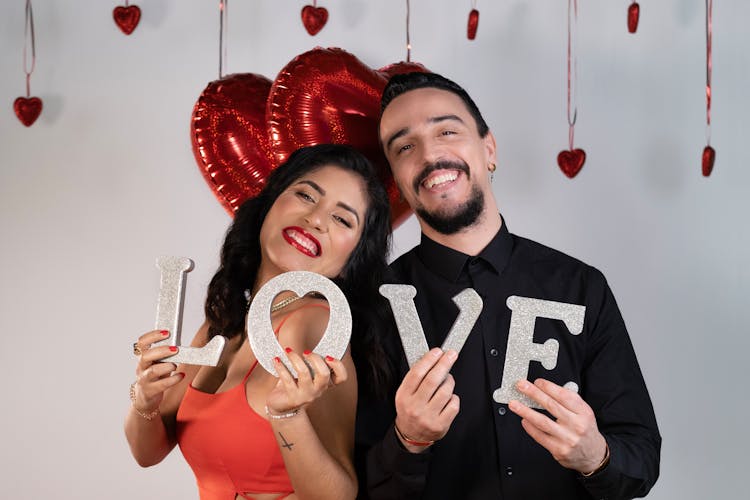 A Woman And A Man Holding Love Letters