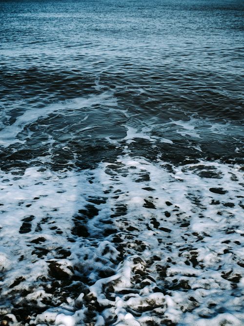 Free A tranquil scene of ocean waves meeting foamy water, capturing nature's beauty. Stock Photo