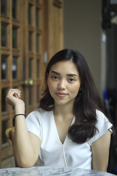 Young Woman Sitting at a Table in a Cafe