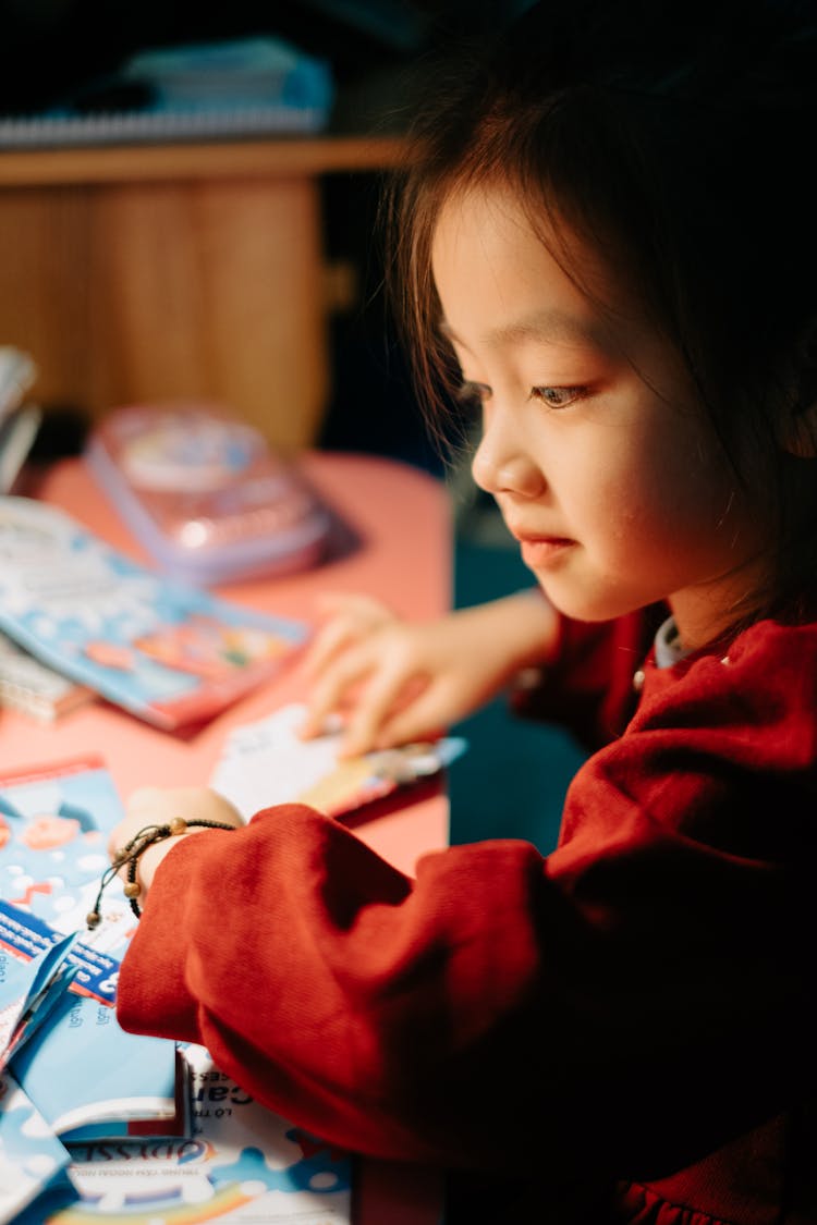 A Girl Sitting At A Desk