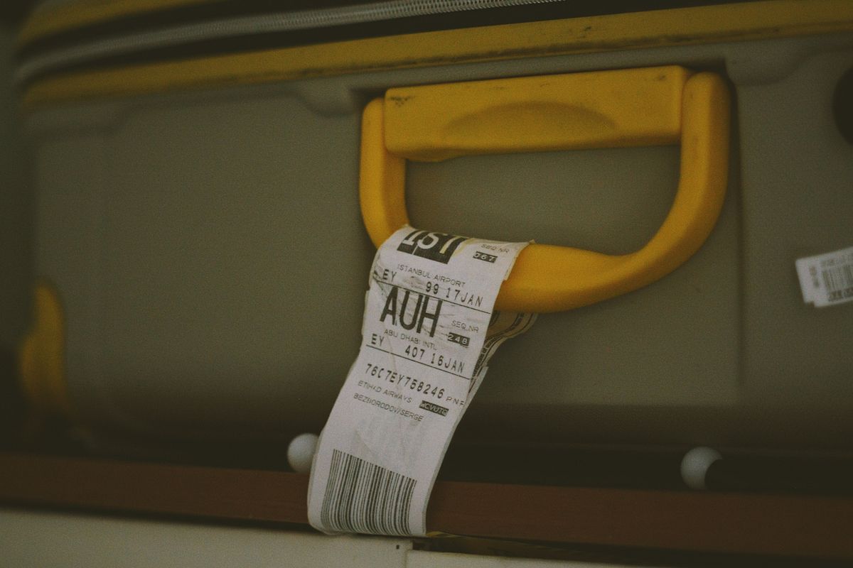 Baggage tag attached to a suitcase handle