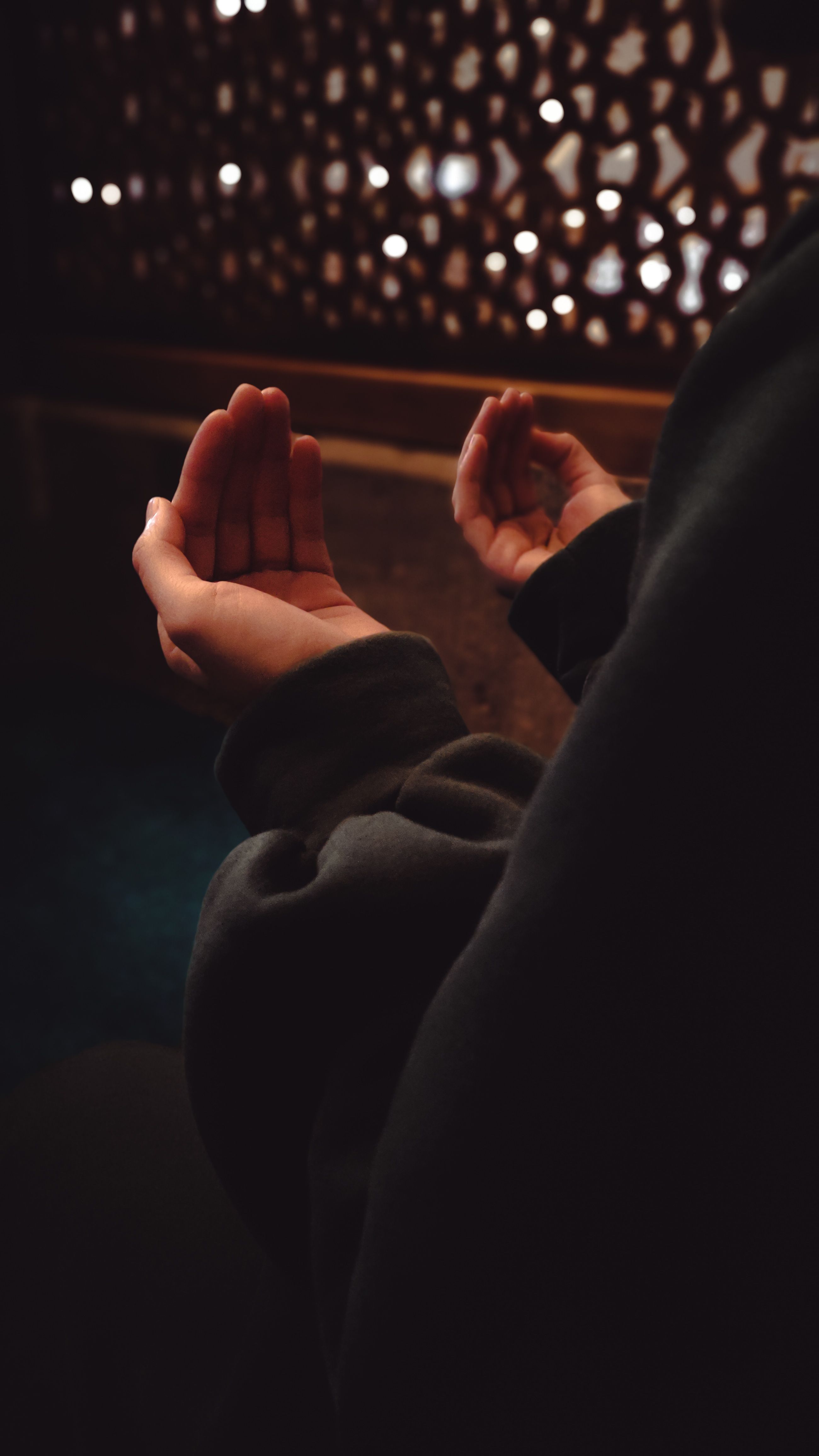 Close-up of hands resting in a calm meditative pose