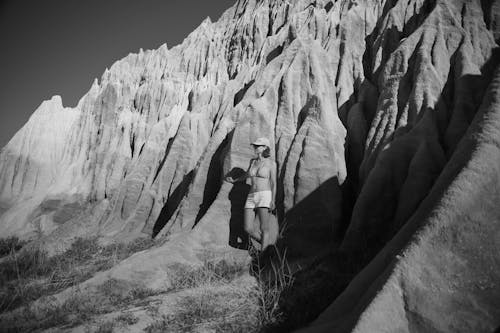 A Woman Standing by a Rock 