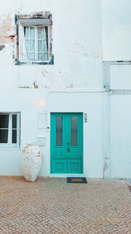 Aquamarine Blue Door of White Building