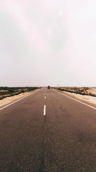 A scenic highway stretches through the serene countryside of Rameswaram, India.