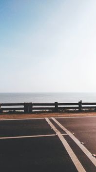 View of a coastal road with railing and sea in Rameswaram, India.