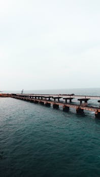 A beautiful aerial view of the iconic Pamban Bridge stretching across the sea in Rameswaram, India.