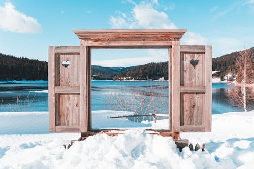 Wooden Window Frame with Shutters at the Lake in Winter