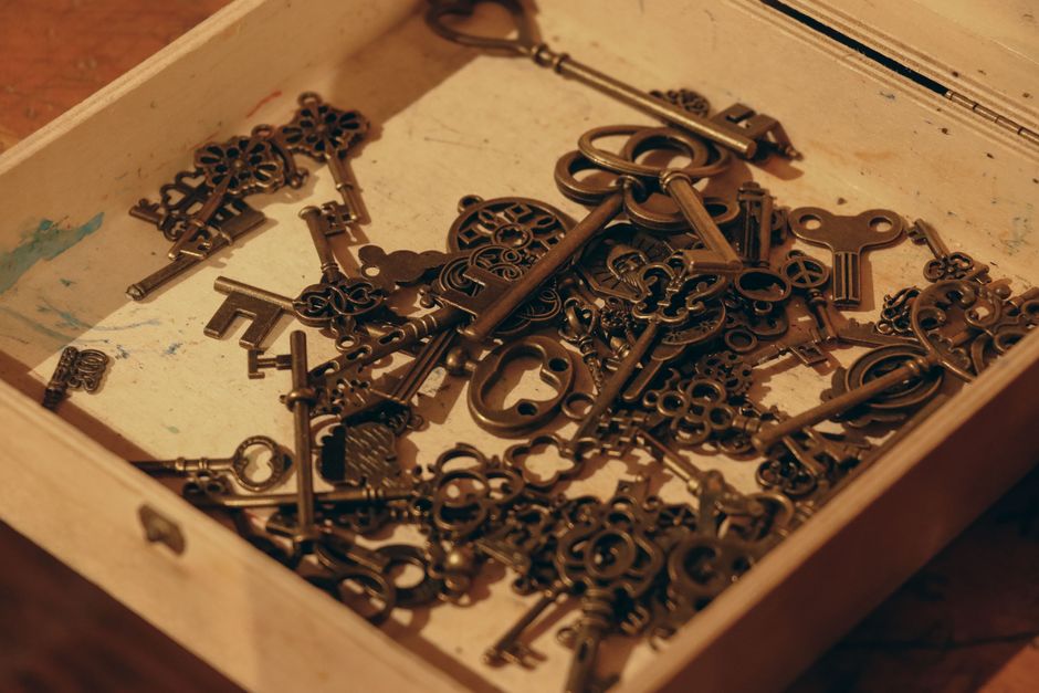 A close-up of vintage keys in a wooden box, evoking nostalgia and mystery.
