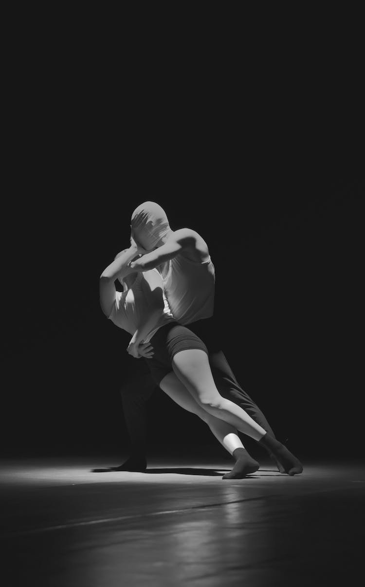 Couple In Masks On Head Dancing In Dark