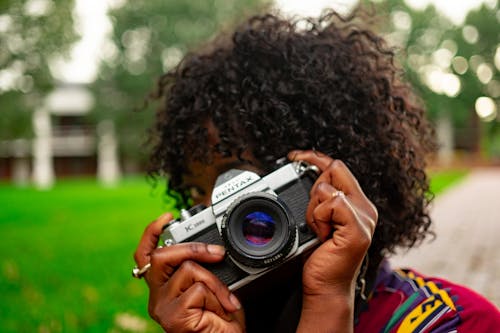 Selective Focus Photography of Woman Holding Camera