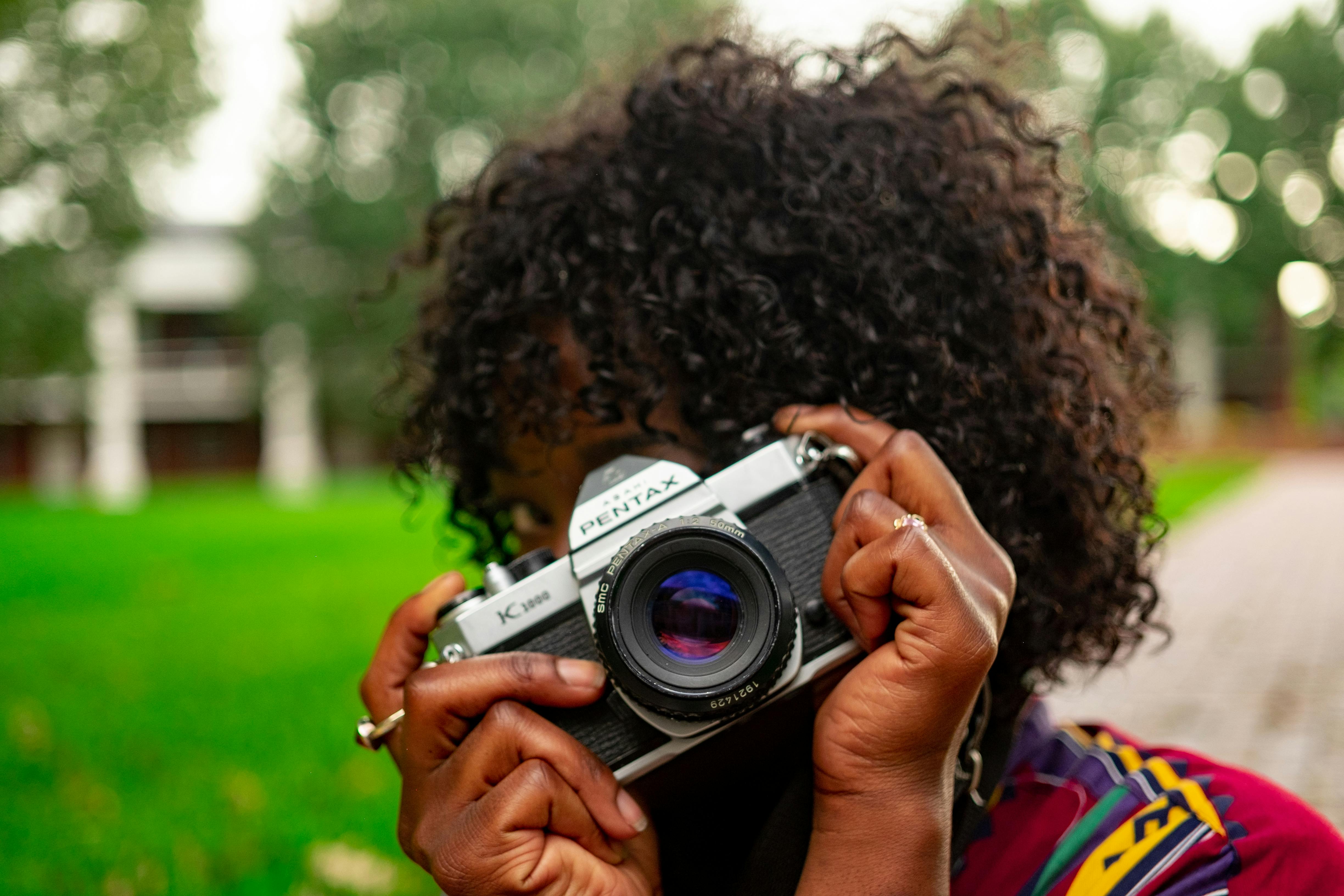 Selective Focus Photography of Woman Holding Camera · Free Stock Photo