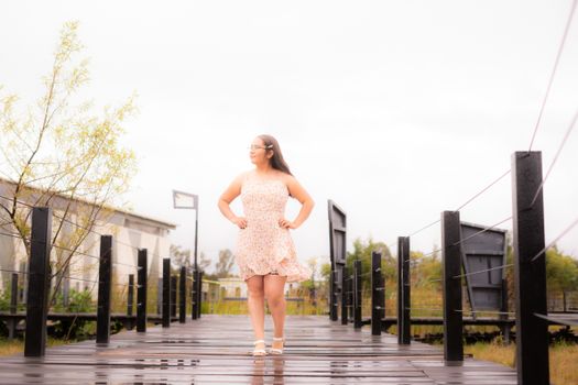 Woman in Dress on Wet Footbridge