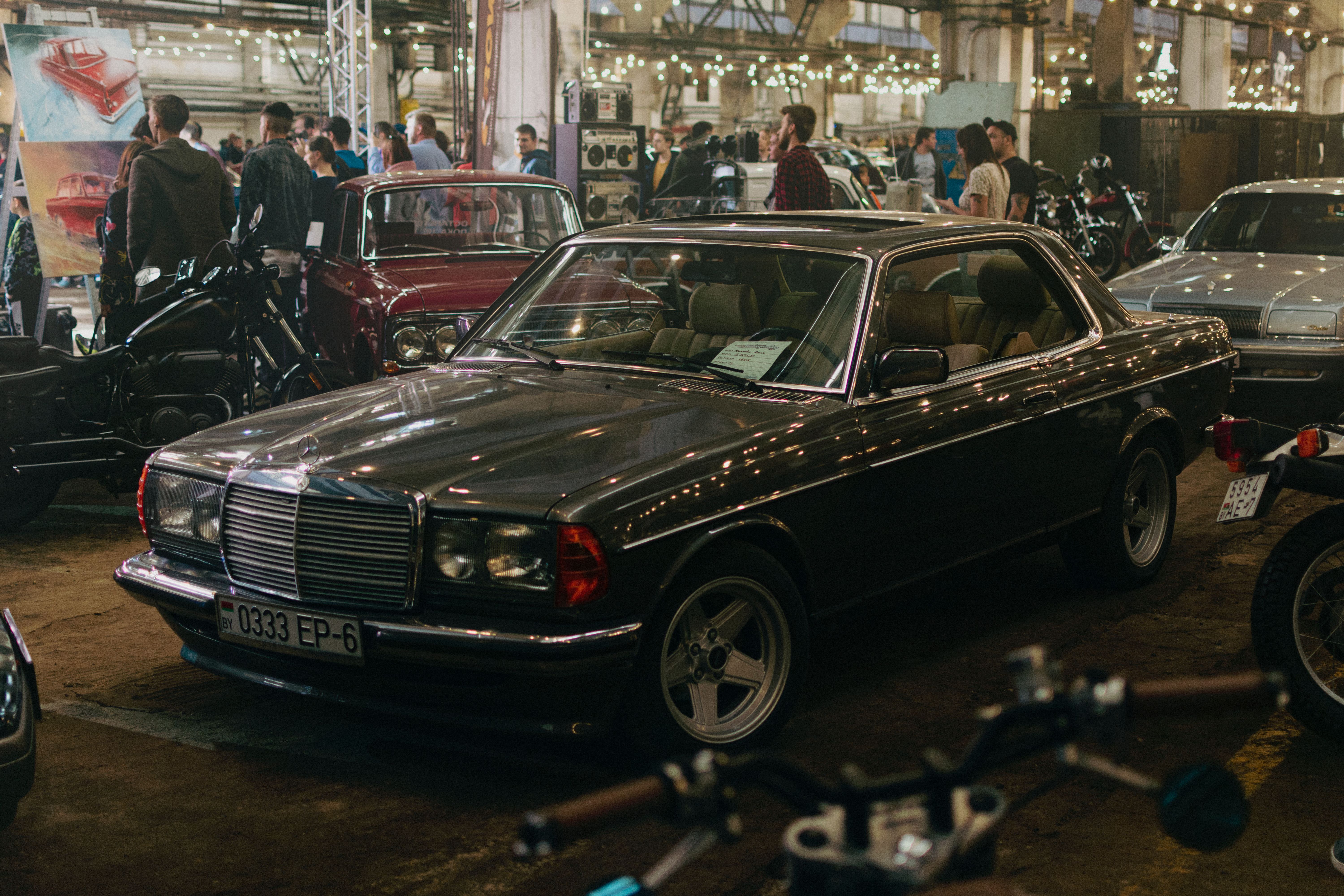 Vintage cars on display at Minsk automotive exhibition with classic Mercedes in focus.