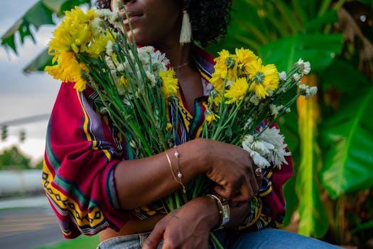A colorful portrait of a woman holding bright chrysanthemums outdoors in Baton Rouge.
