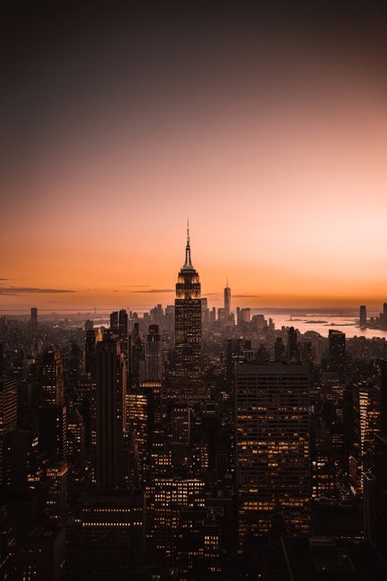 A breathtaking view of New York City's skyline at sunset, featuring iconic skyscrapers.