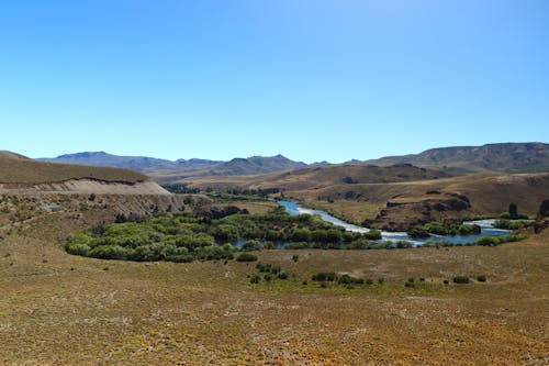 Clear Sky over River and Hills