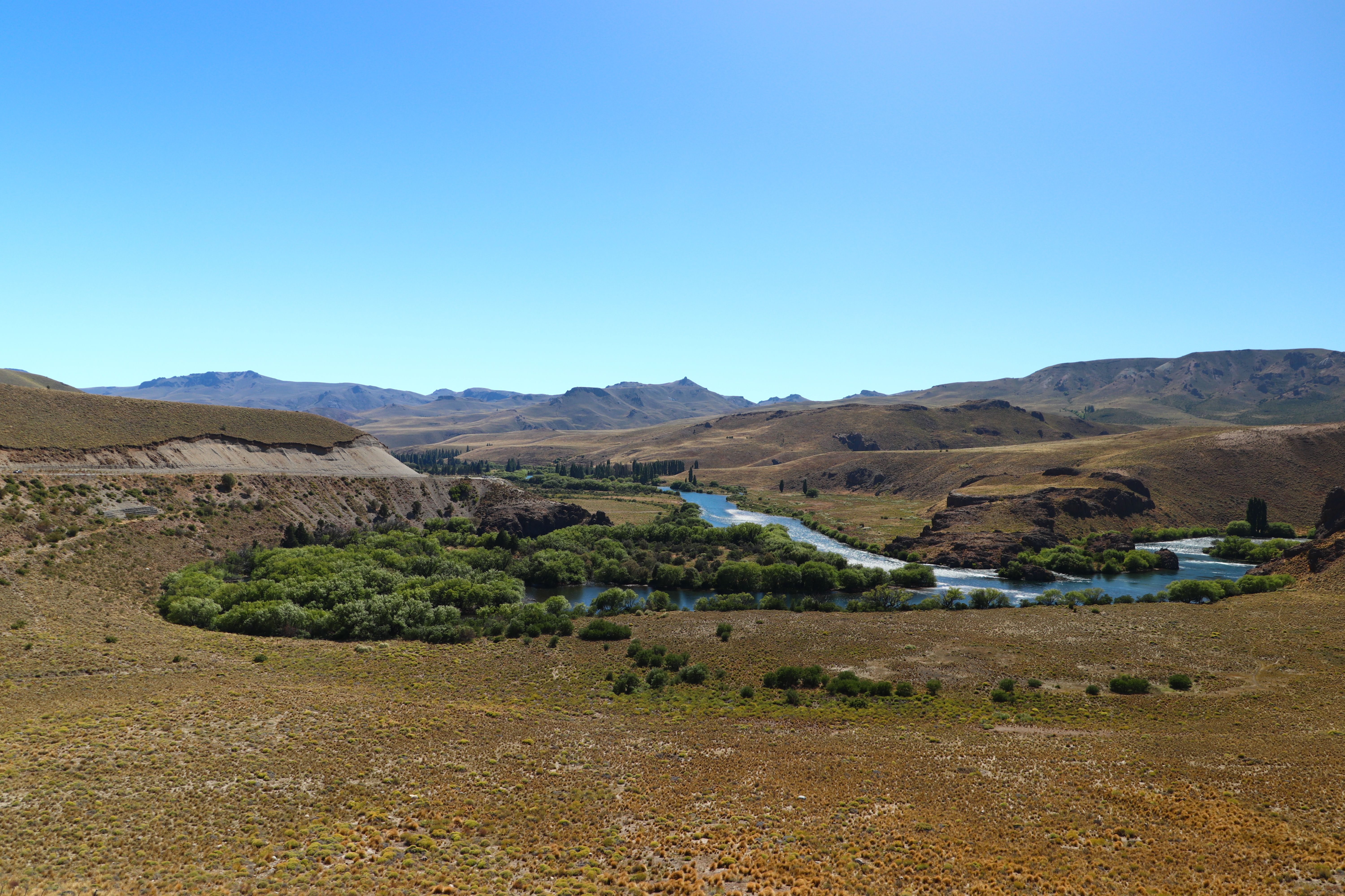 Clear Sky over River and Hills · Free Stock Photo