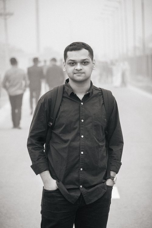Free A young adult man in black attire poses confidently on a foggy street in Dhaka. Stock Photo