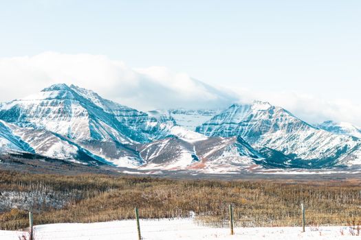 Majestic snow-covered mountains in Waterton Park, Alberta, Canada captured in winter.