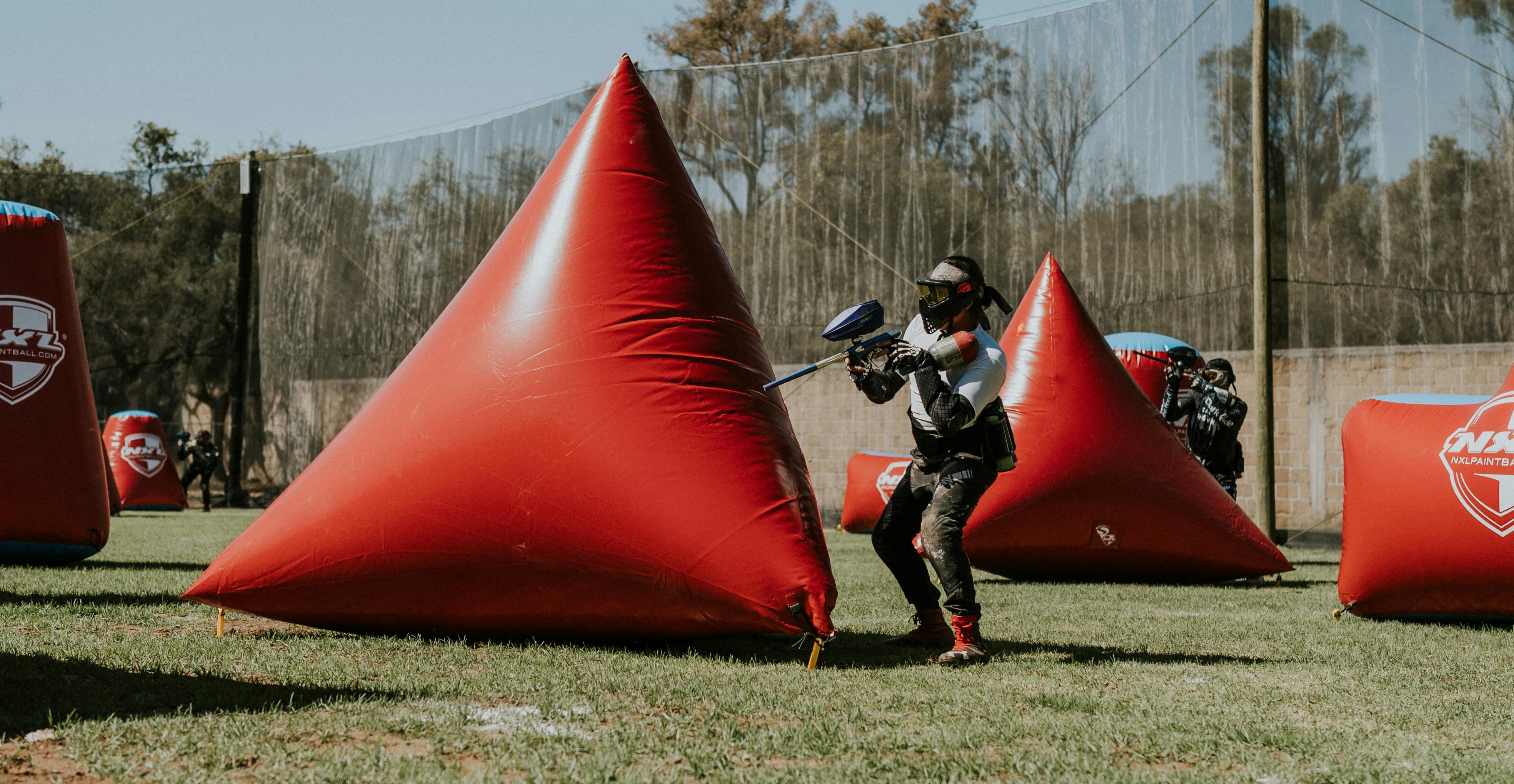 Action-packed paintball game with players in protective gear on a sunny outdoor field. Prescription Goggle Inserts - Action-packed paintball game with players in protective gear on a sunny outdoor field.