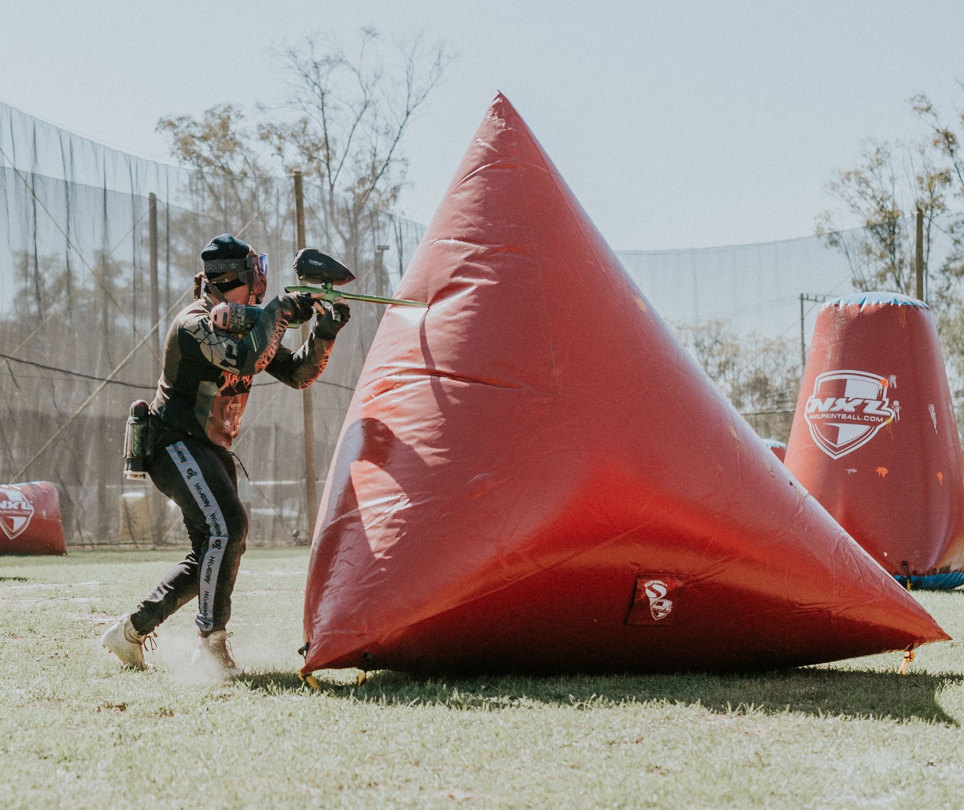 Person behind Cover Playing Paintball