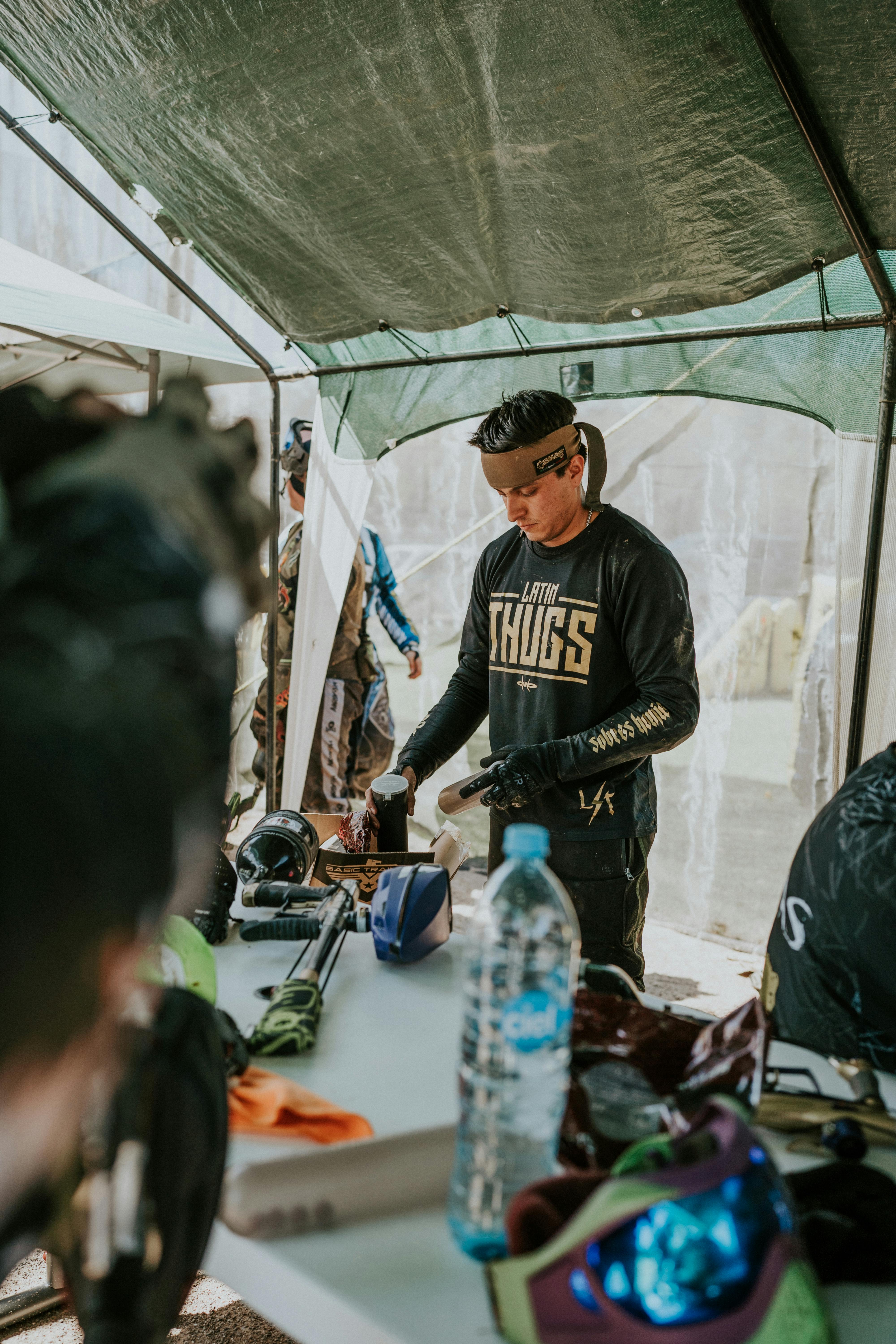 Group of adults getting ready for a paintball game under a tent outdoors. Prescription Goggle Inserts - Group of adults getting ready for a paintball game under a tent outdoors.